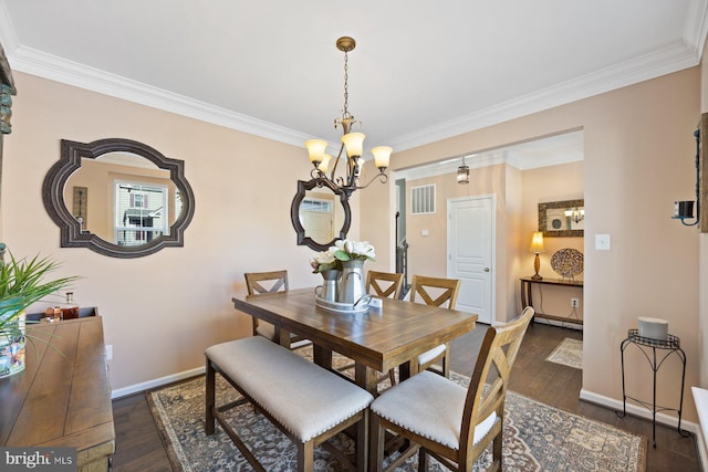 dining space with ornamental molding and dark hardwood / wood-style flooring