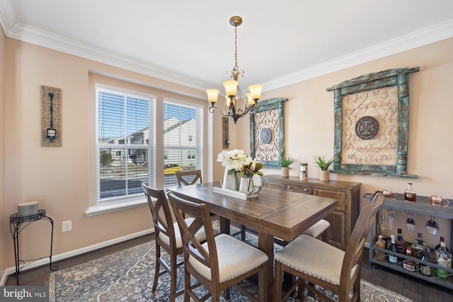 dining space featuring crown molding, a notable chandelier, and dark hardwood / wood-style flooring