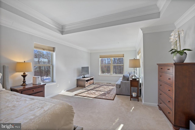 bedroom with crown molding, light colored carpet, and a tray ceiling