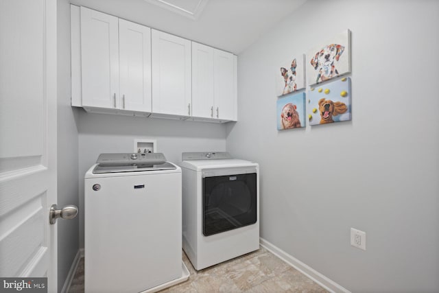 laundry room with cabinets and separate washer and dryer