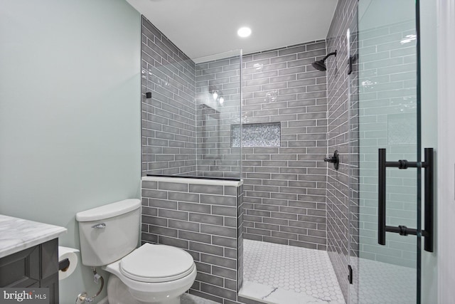 bathroom featuring walk in shower, vanity, and toilet