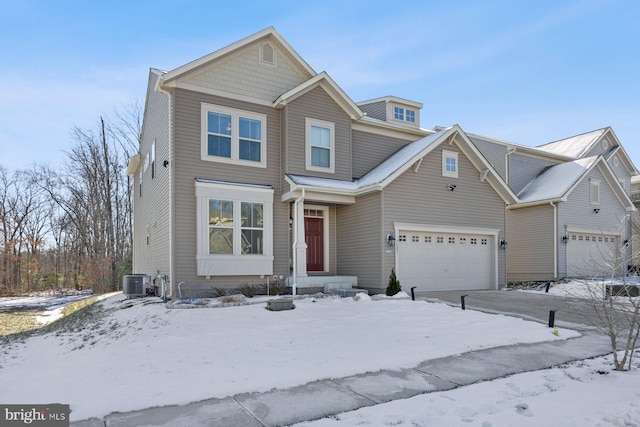 view of property with central AC unit and a garage