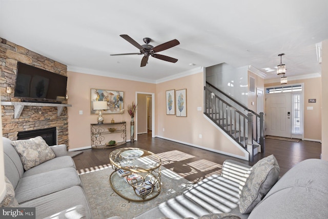 living room featuring dark hardwood / wood-style flooring, a fireplace, and ornamental molding