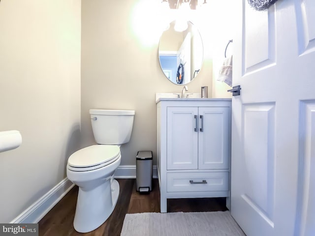 bathroom with vanity, hardwood / wood-style floors, and toilet