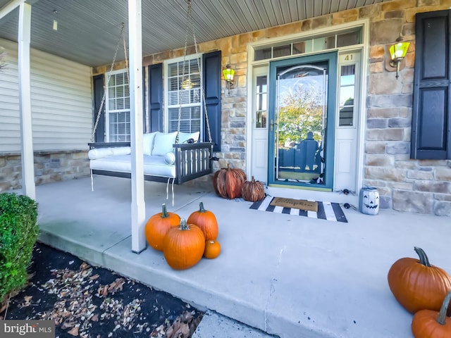 view of exterior entry with a porch