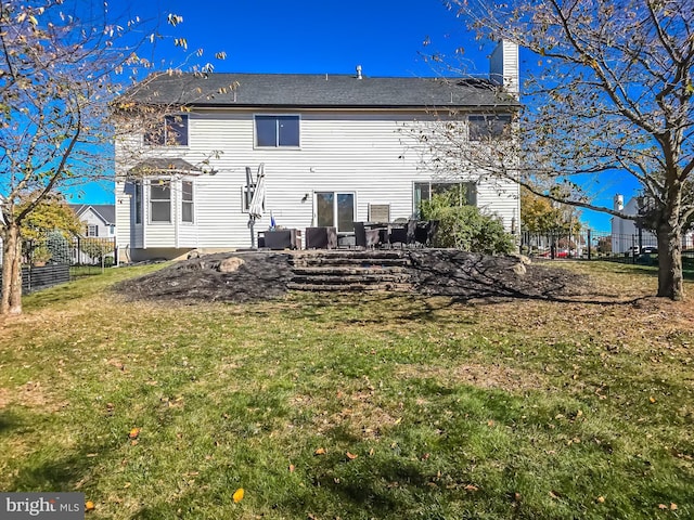 rear view of property with a yard and a patio area