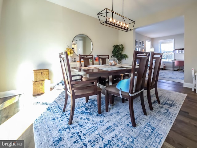 dining room featuring dark hardwood / wood-style floors and a notable chandelier