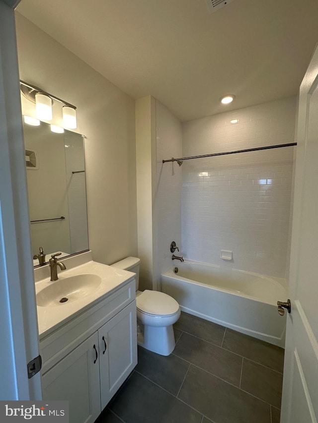 full bathroom with tiled shower / bath, vanity, tile patterned floors, and toilet