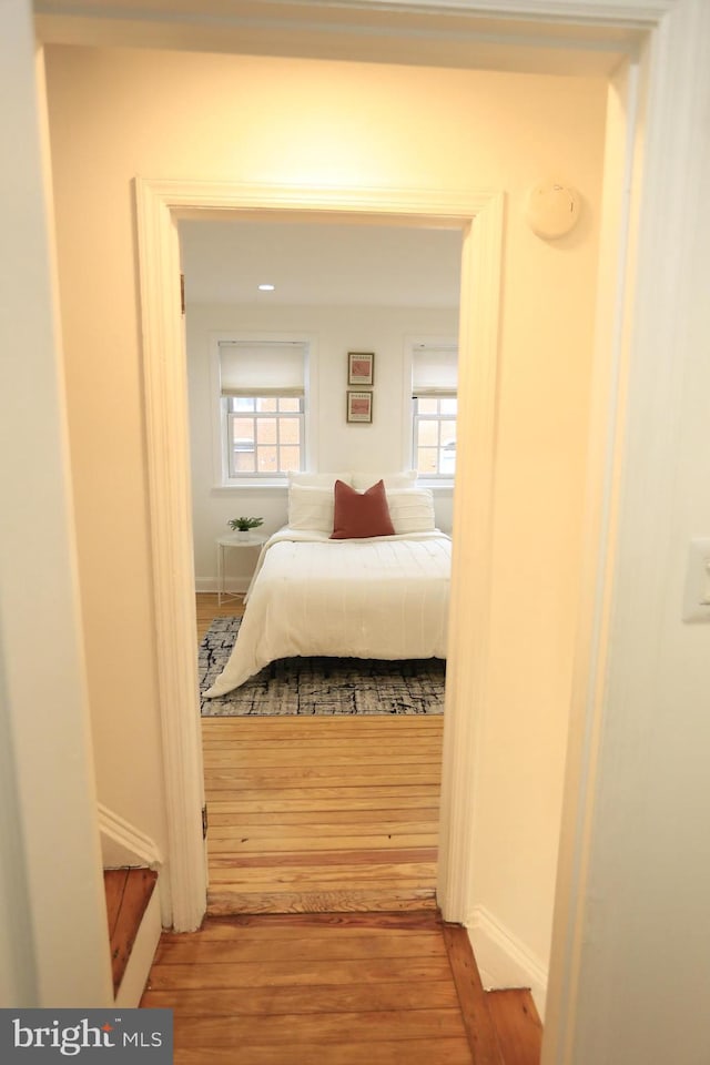 bedroom with hardwood / wood-style flooring