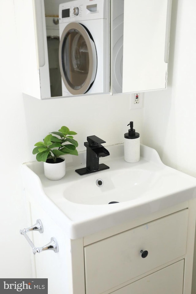 bathroom featuring washer / clothes dryer and vanity