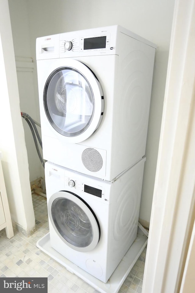 laundry area with stacked washer / drying machine