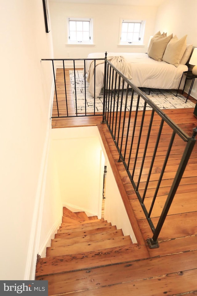 stairs featuring hardwood / wood-style floors