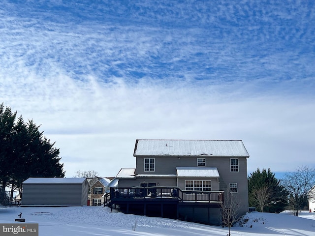 view of front facade featuring an outbuilding and a wooden deck