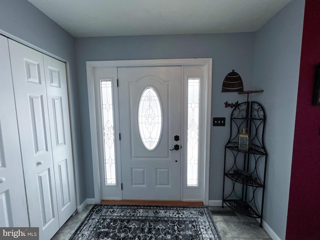 foyer with a healthy amount of sunlight and baseboards