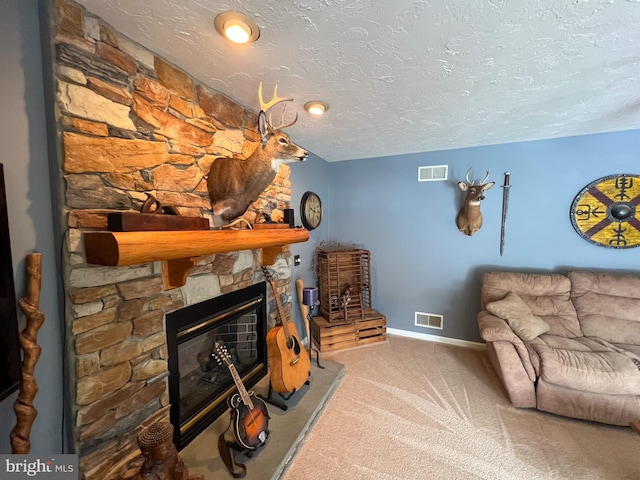 living room with carpet floors, visible vents, a textured ceiling, and a stone fireplace