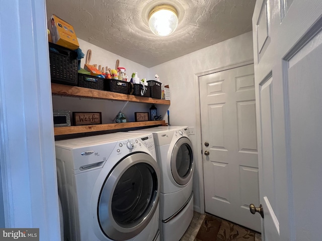 washroom featuring laundry area, a textured ceiling, dark wood-style floors, and washer and dryer