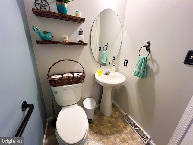 bathroom with visible vents, toilet, and baseboards