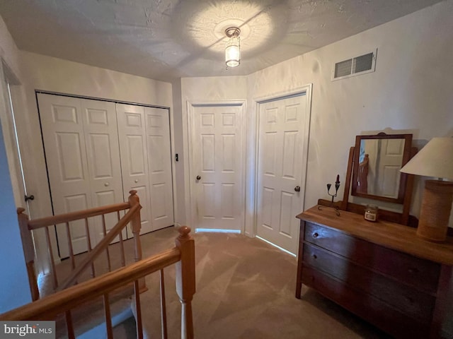 interior space with a textured ceiling and visible vents