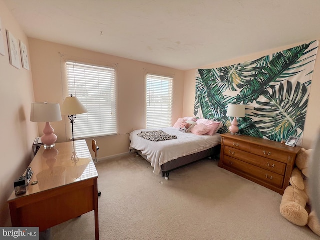 carpeted bedroom featuring baseboards