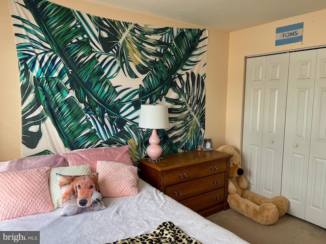 bedroom with carpet and a closet