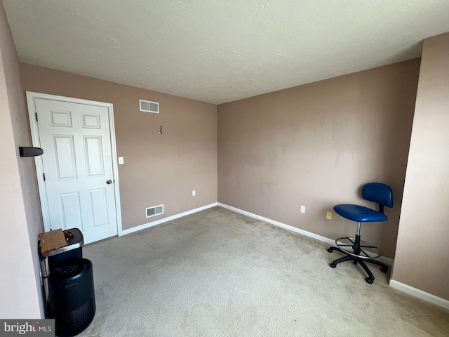 interior space featuring carpet floors, baseboards, and visible vents