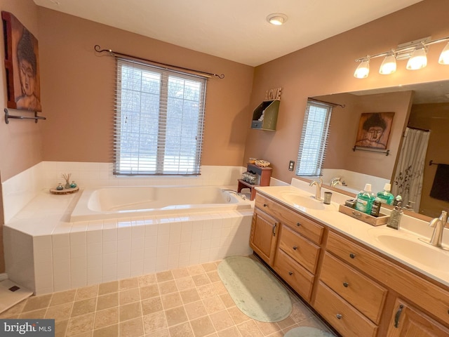 bathroom featuring double vanity, a sink, and a bath