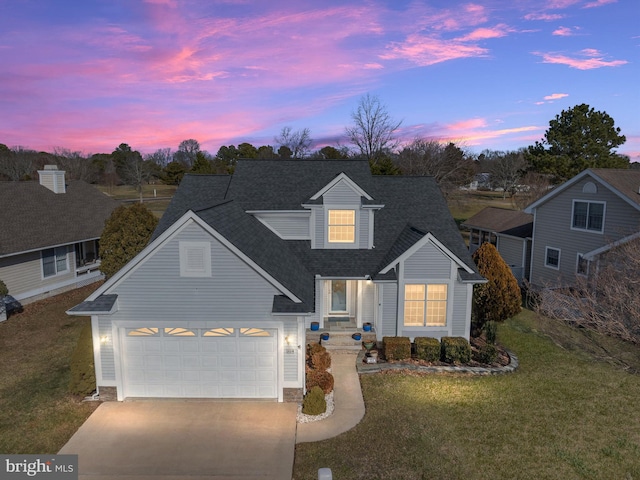 view of front of house with a yard and a garage