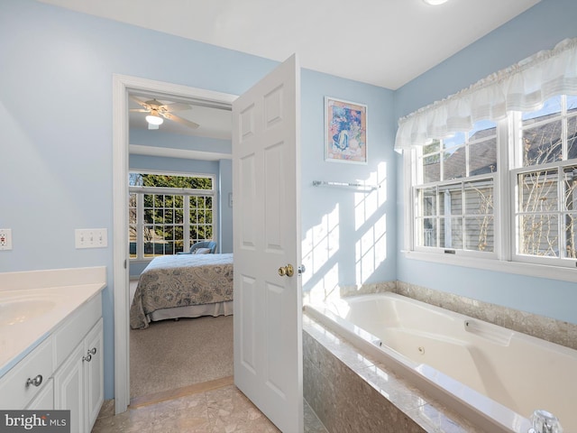 bathroom with vanity and a relaxing tiled tub