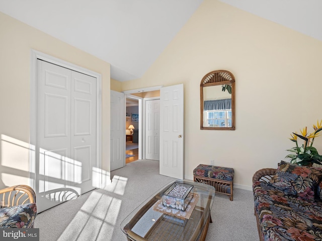 carpeted living room featuring high vaulted ceiling