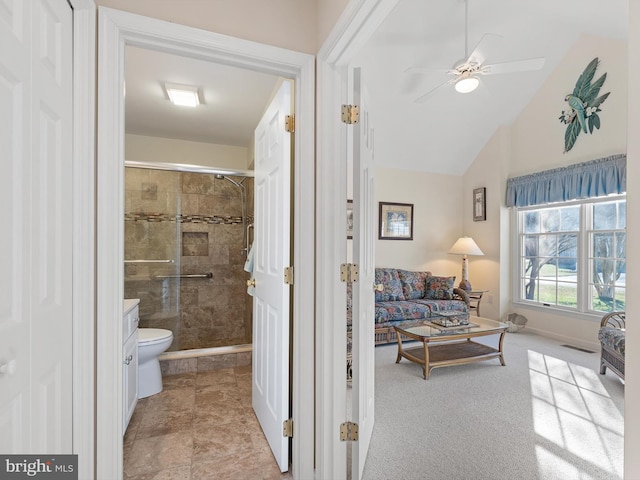 bathroom with ceiling fan, lofted ceiling, toilet, and an enclosed shower