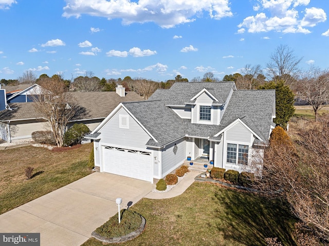 view of front of property with a garage and a front lawn