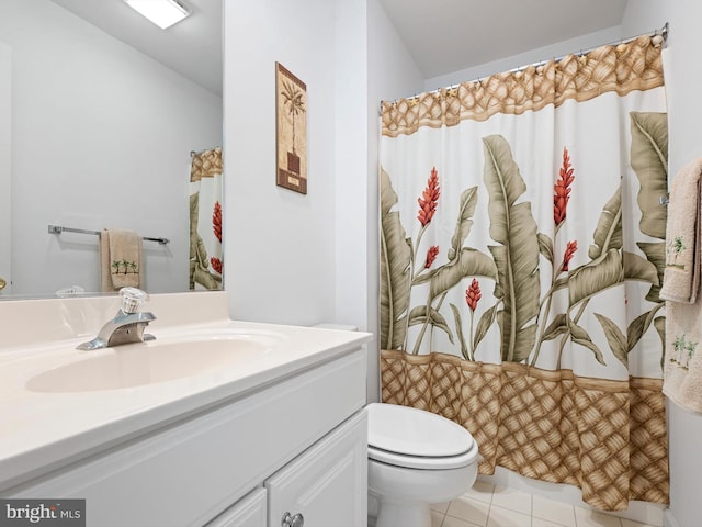 bathroom featuring vanity, tile patterned floors, and toilet