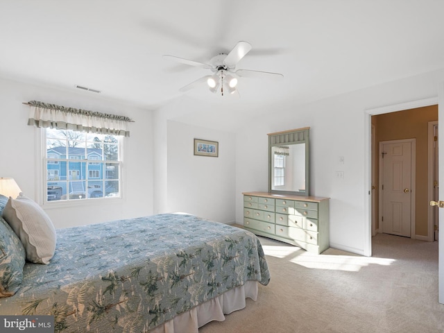 bedroom featuring light colored carpet and ceiling fan