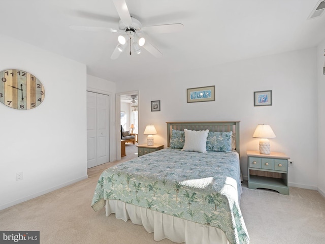 carpeted bedroom with a closet and ceiling fan