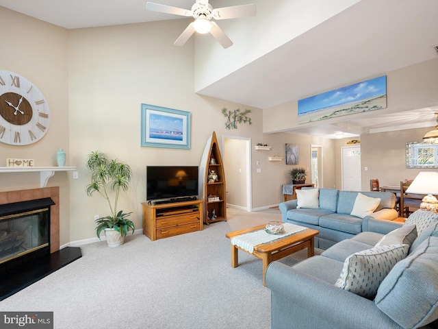 living room with a fireplace, ceiling fan, and carpet flooring