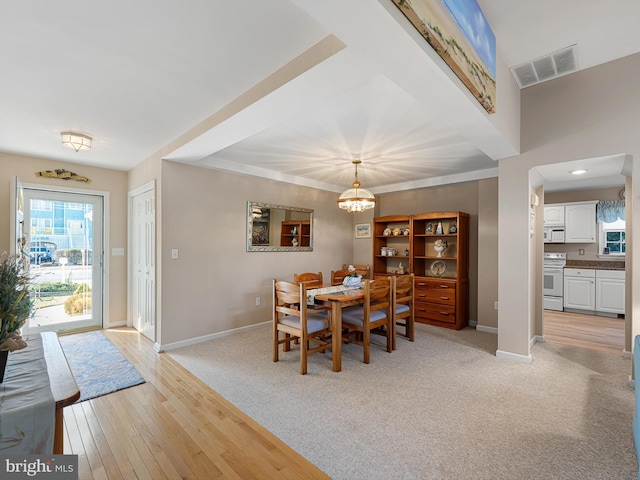 dining area featuring a notable chandelier and light hardwood / wood-style floors