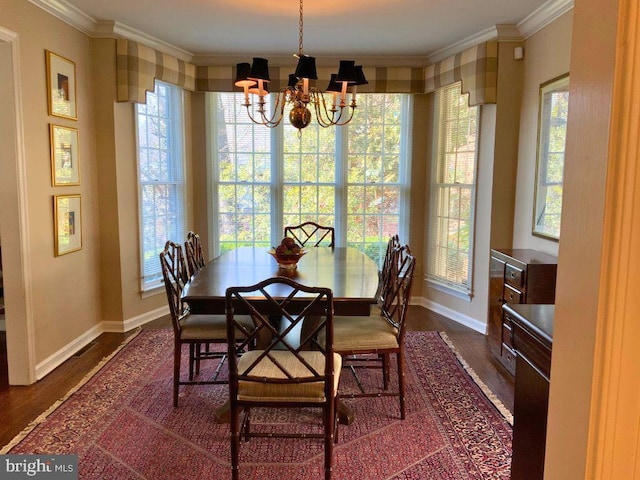 dining area with crown molding, a chandelier, and dark hardwood / wood-style flooring