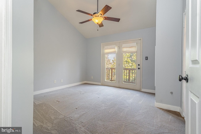 empty room featuring vaulted ceiling, ceiling fan, baseboards, and light colored carpet