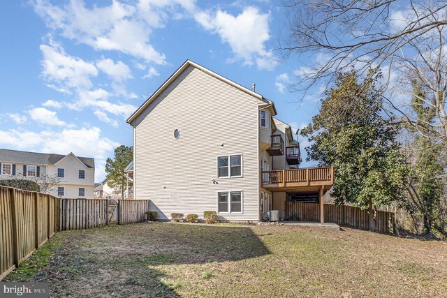 rear view of property featuring a fenced backyard, a lawn, and central AC