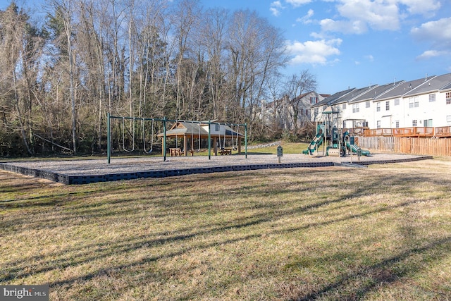 community play area with a yard and fence