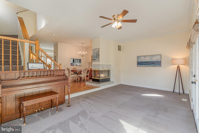 interior space with a multi sided fireplace, visible vents, baseboards, stairs, and ornamental molding