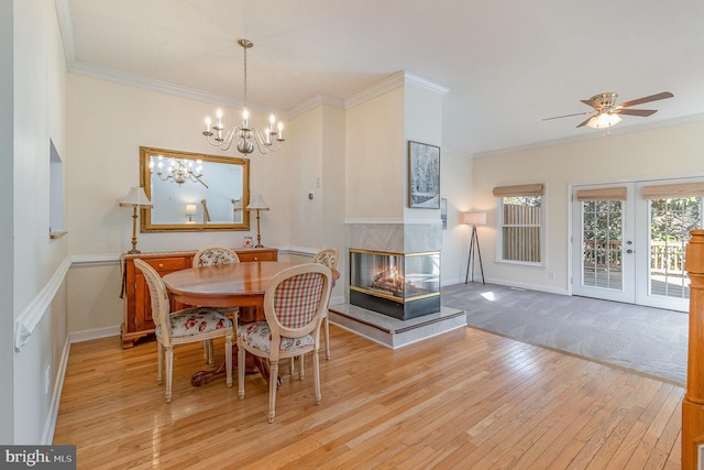 dining space with ornamental molding and light wood finished floors