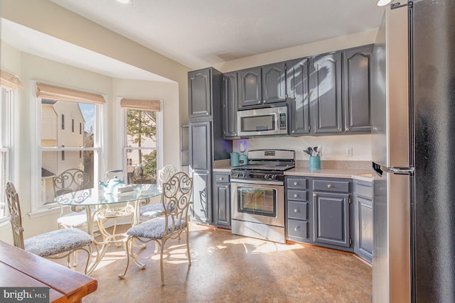 kitchen featuring gray cabinets, appliances with stainless steel finishes, and light countertops