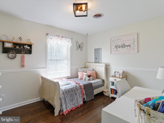 bedroom with dark hardwood / wood-style flooring and electric panel