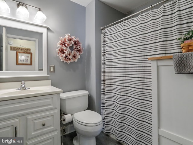 bathroom featuring vanity, a shower with curtain, and toilet