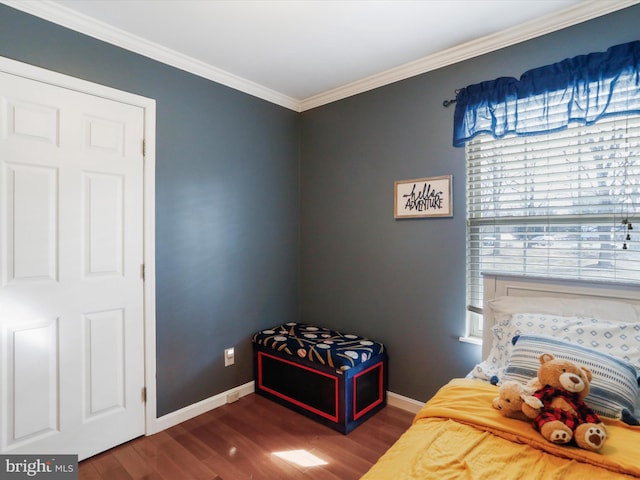 bedroom featuring dark hardwood / wood-style flooring and ornamental molding