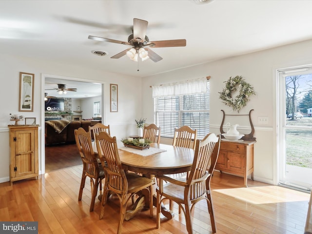 dining area with a wealth of natural light and light wood-type flooring