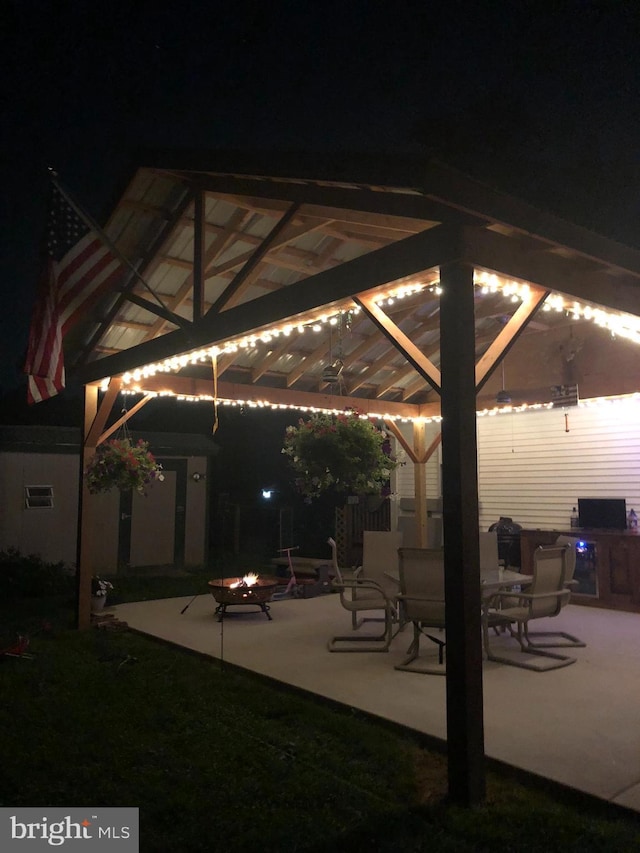 patio at night featuring a gazebo