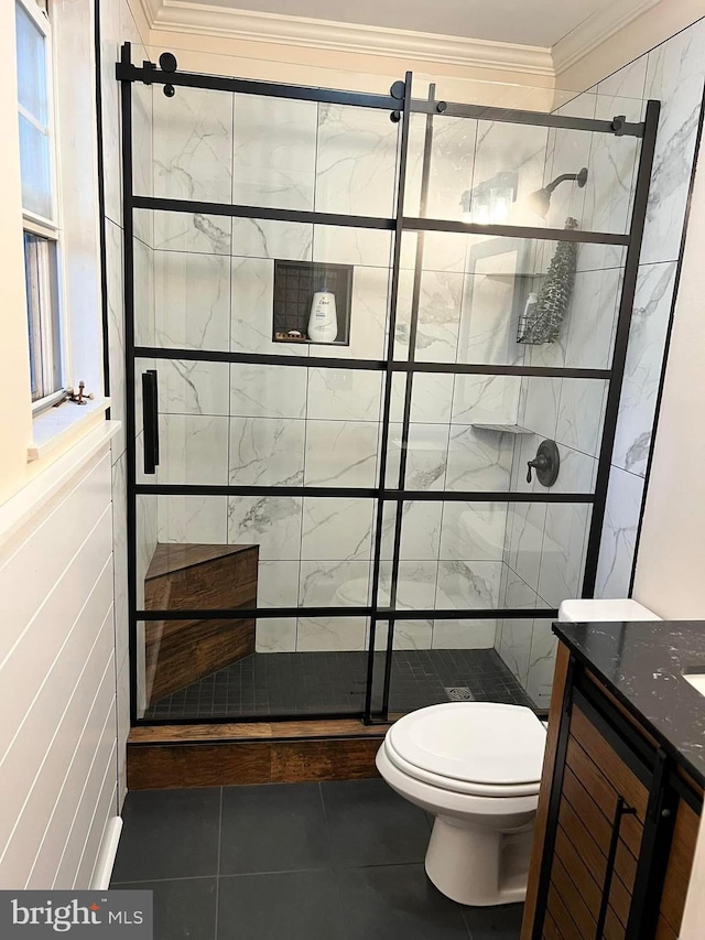 bathroom with a shower with shower door, vanity, ornamental molding, toilet, and tile patterned floors