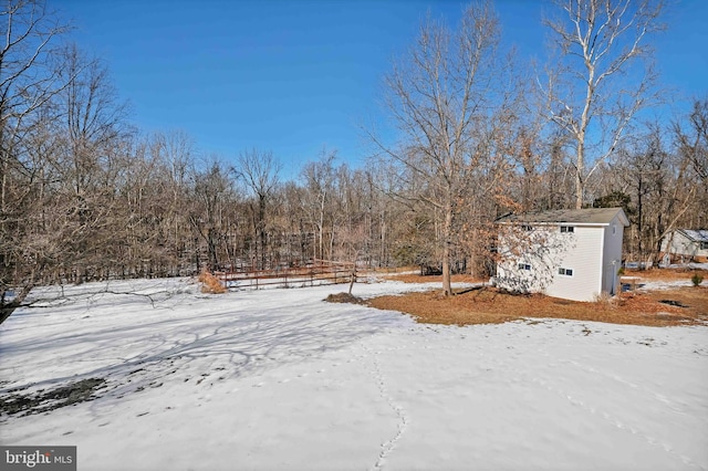 yard layered in snow with an outdoor structure